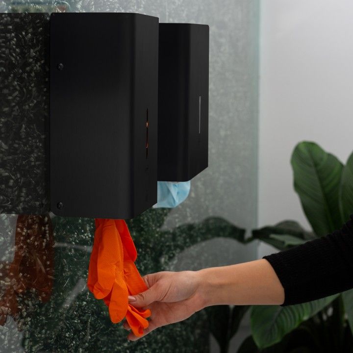 Wall dispenser for disposable rubber gloves
